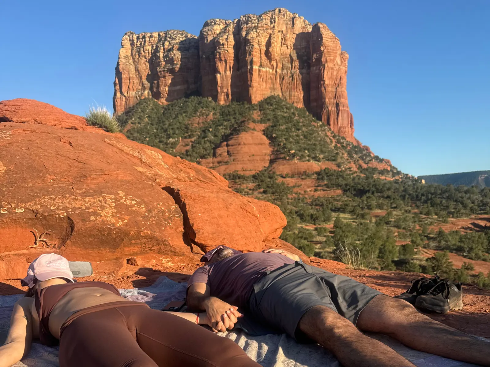 a couple holding hands on baby bell a couple holding hands following a reiki and sound healing in Sedona